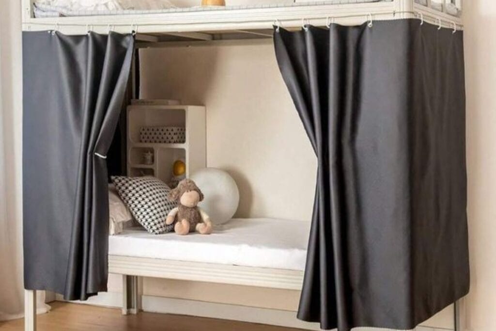 Bed for kids having Bunk Bed Curtains , pillow and a teddy on mattress