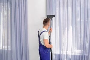How to Clean Dusty Curtains: A Step-by-Step Guide, featuring a cleaning expert demonstrating effective curtain cleaning techniques.