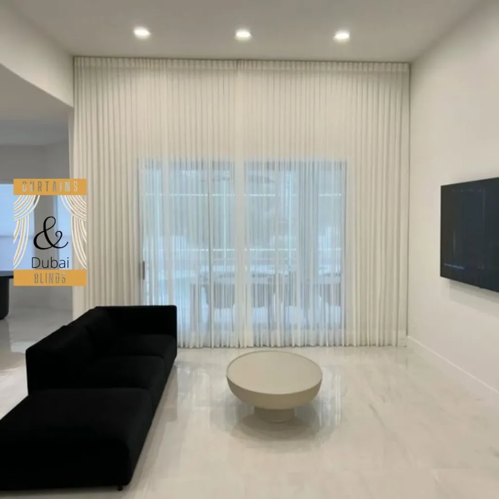 Elegant sheer curtains installed in a modern Dubai apartment living room, showcasing premium curtain designs for modern apartments.