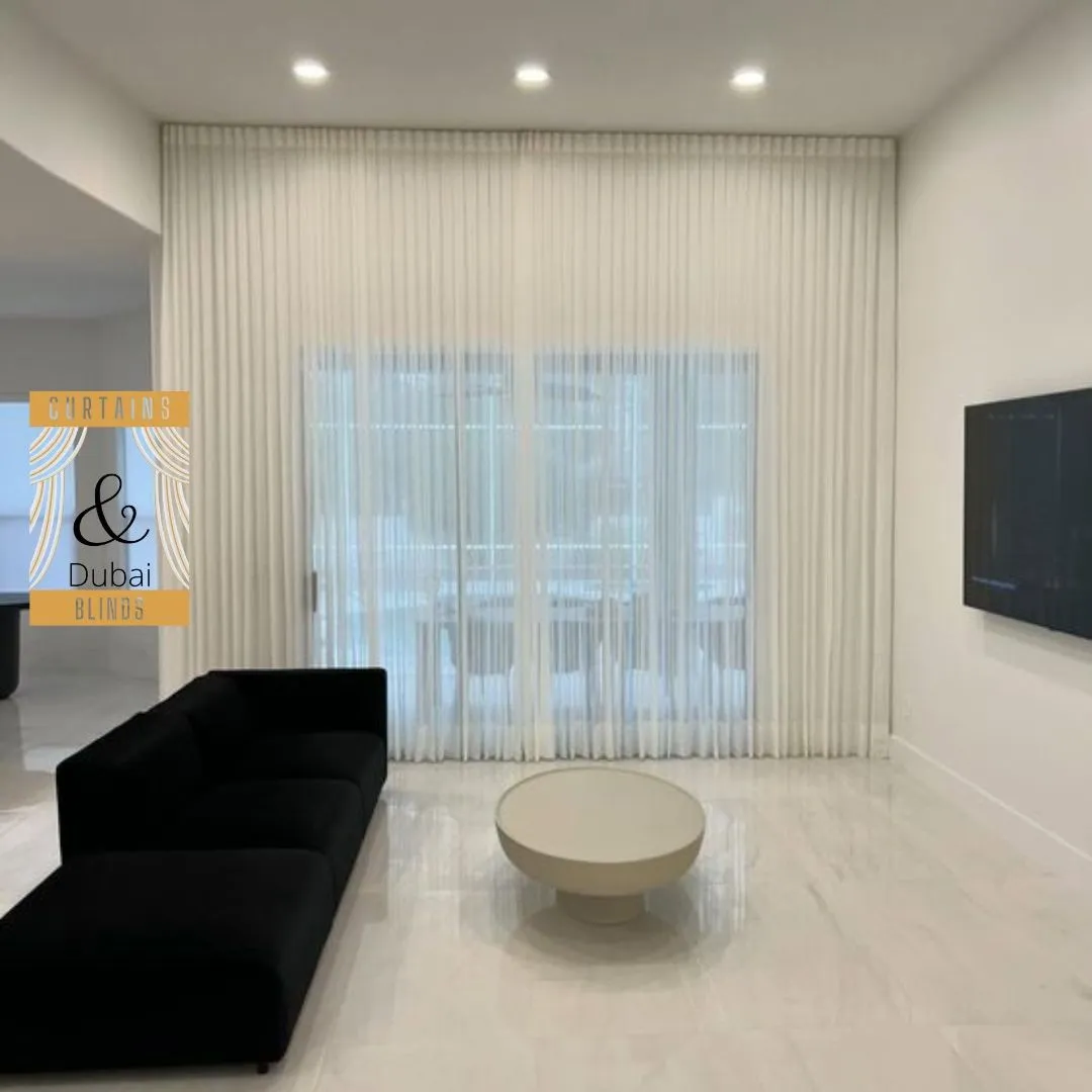 Elegant sheer curtains installed in a modern Dubai apartment living room, showcasing premium curtain designs for modern apartments.